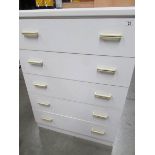 A white 5 drawer chest.