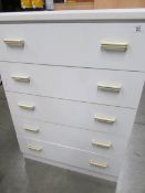 A white 5 drawer chest.