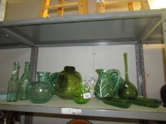 A mixed lot of green glass and pottery items (1 shelf)