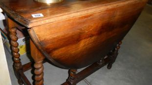 An oak barley twist gate leg table.