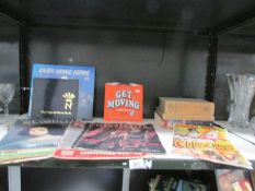 A shelf of books, magazines, programmes etc.