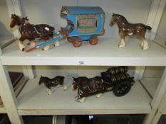 A gypsy caravan with horse, a beer cart with shire horse, a shire horse and 2 other horses.