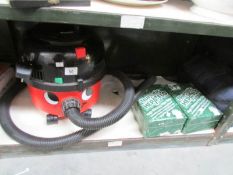 A Henry vacuum cleaner and 2 boxes of Henry bags.