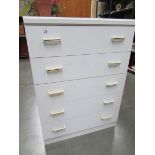 A white 5 drawer chest.