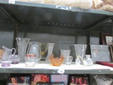 A shelf of assorted glass ware.