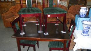 A mahogany table and 4 chairs,.