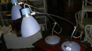 A pair of angle poise reading lamps.