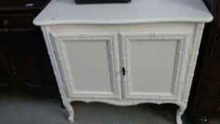 A white 2 door cupboard.