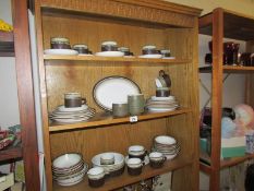 3 shelves of stoneware tea and dinner ware.