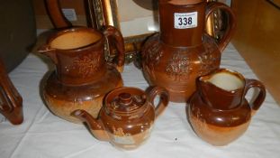 3 Doulton stone ware jugs and a teapot, some a/f.