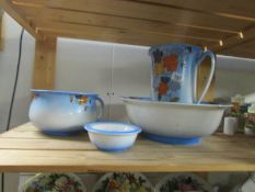 A 4 piece jug and basin set with chamber pot and soap dish.