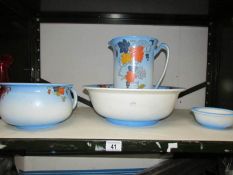 A jug, basin, chamber pot and soap dish.