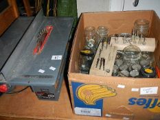 A circular bench saw and a box of screws etc.