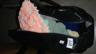 A bag of hand knitted hats.