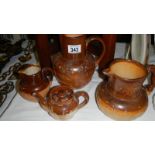 3 Doulton stoneware jugs and a teapot, a/f.