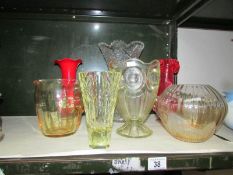 6 coloured glass vases and a glass jug.