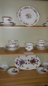 3 shelves of tea ware.