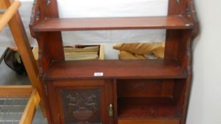 A mahogany wall cabinet.