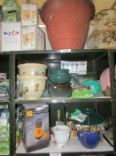 4 shelves of garden pots and accessories.