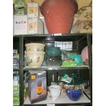 4 shelves of garden pots and accessories.