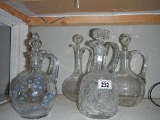 5 glass wine jugs including cut glass, etched glass and hand painted examples.