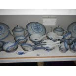 A shelf of modern oriental table ware including rice bowl, teapots, ladles etc.