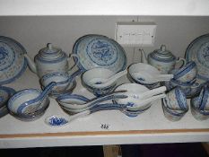 A shelf of modern oriental table ware including rice bowl, teapots, ladles etc.