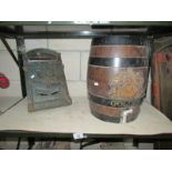 A cast iron letter box and an old barrel,