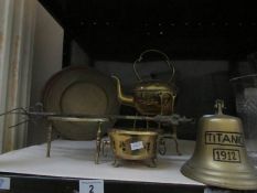 A brass kettle on stand, a brass trivet and other brass ware.