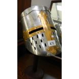 A replica crusader/Knight Templar helmet on stand.