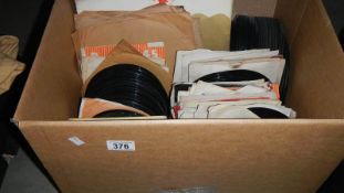 A box of 45 rpm and LP records.