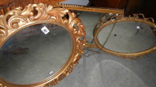 A circular gilt framed mirror and 2 others.