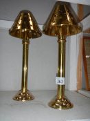 A pair of brass candle lamps.