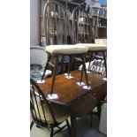An oak drop leaf table and 4 chairs.