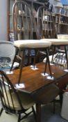 An oak drop leaf table and 4 chairs.