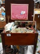 A sewing box on legs and contents including haberdashery.
