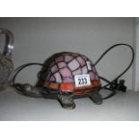 A Tiffany style table lamp in the shape of a tortoise.