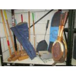 A shelf of tennis rackets, croquet items etc.