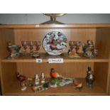 A collection of pheasant ornaments and figurines, 2 shelves.