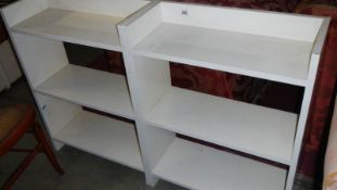 2 white painted book cases.