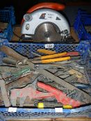 A circular saw and a box of tools.