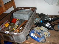 A drill , sander, saw and box of tools,.