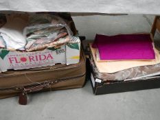 A suitcase and 2 boxes of fabrics and curtains in various designs and weights,