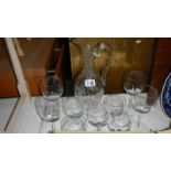 An etched glass jug and a quantity of wine glasses.