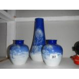 A pair of blue and white vases with snow scenes and a taller example (tall vase a/f)