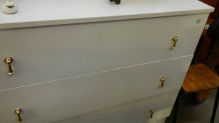 A white 3 drawer chest.