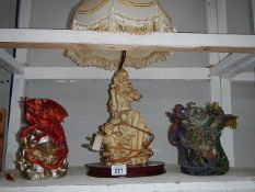 A figural table lamp and 2 dragon figures, one a/f.