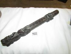 An oriental carved wood baton,.