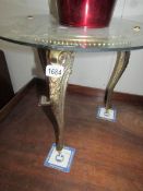 A metal based table with glass top.