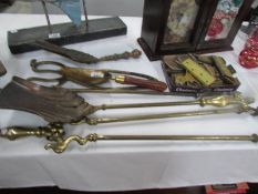 A set of brass fire irons, other fire implements and a quantity of brass hinges.